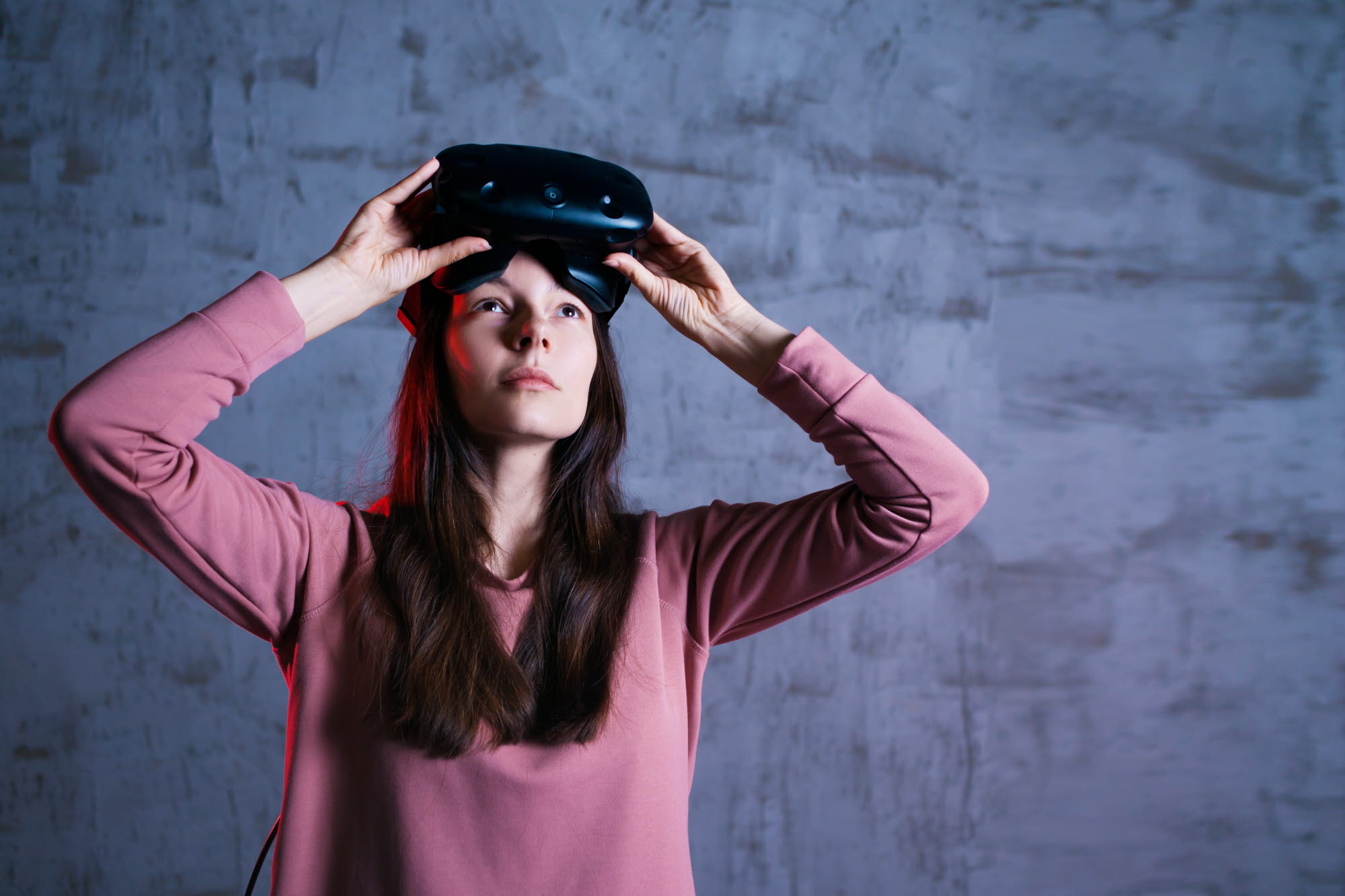Woman removing her VR headset