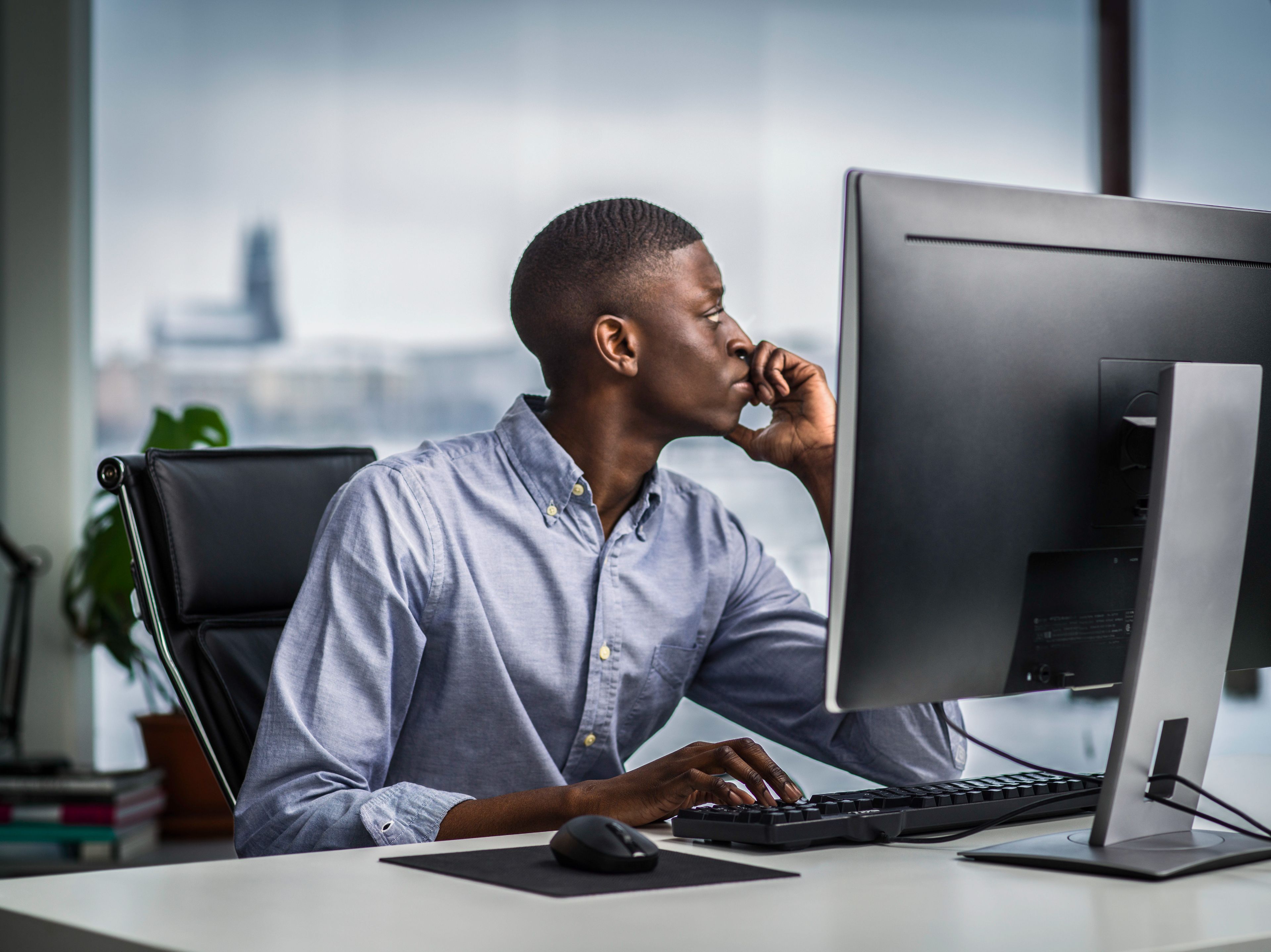 Man looking away from his computer