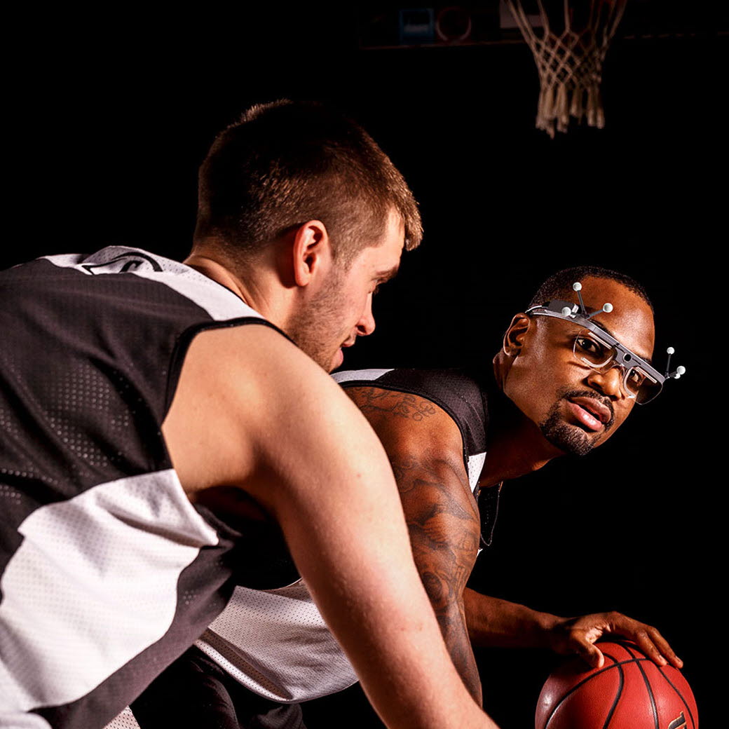 person playing basketball using Tobii Pro glasses 2 and motion capture markers