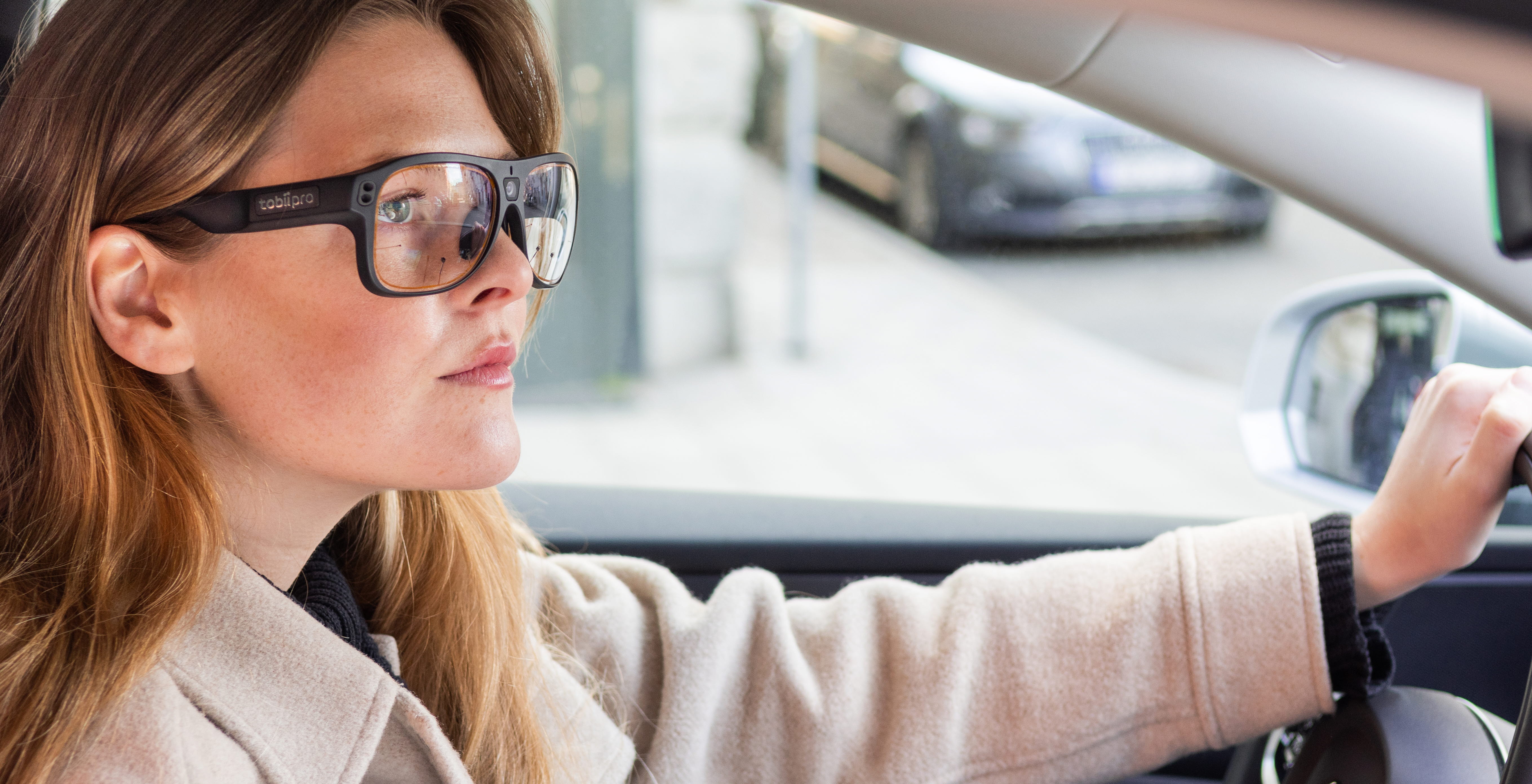 Woman driving a car using Tobii Pro Glasses 3 wearable eye trackers