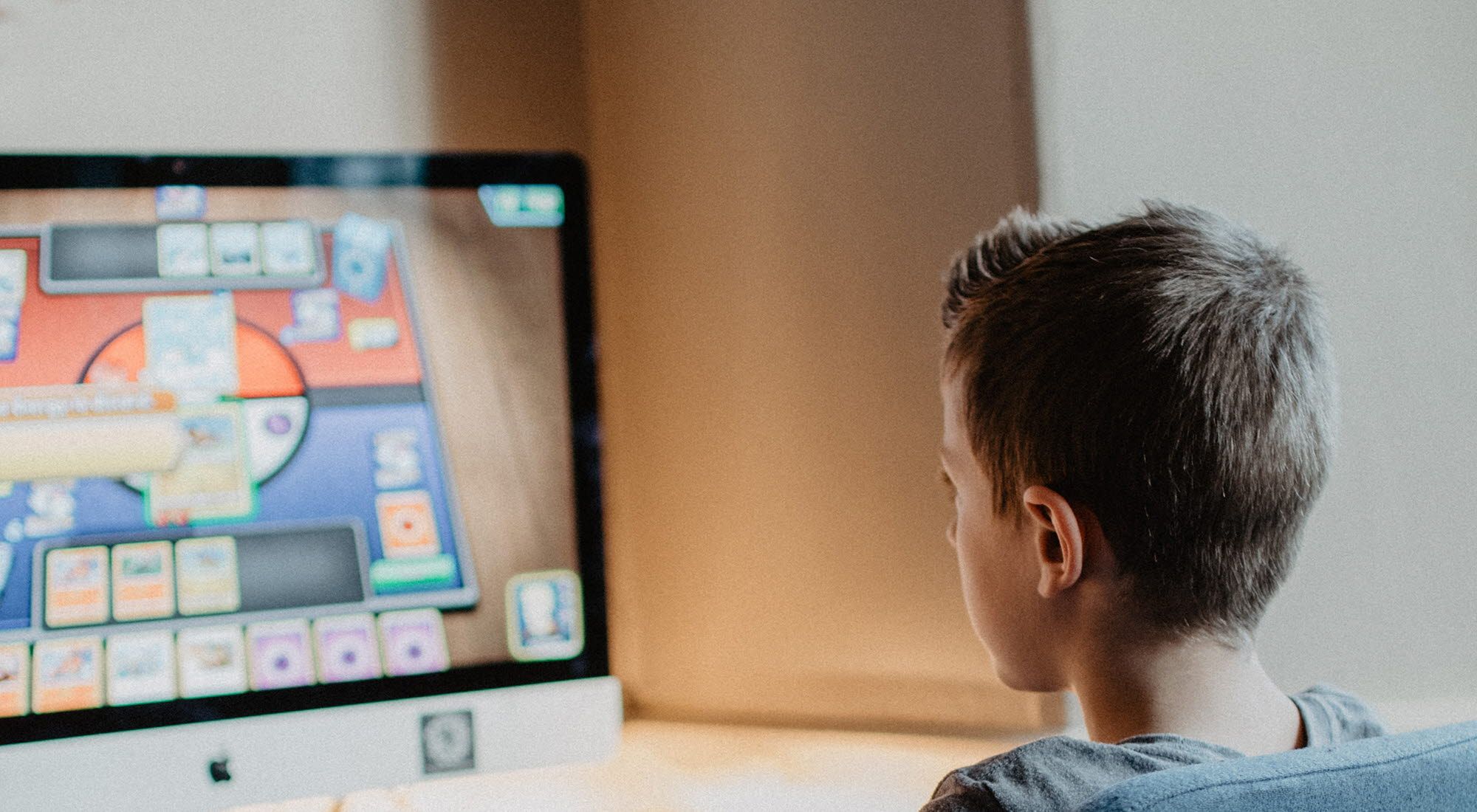Child sitting in front of the computer playing games